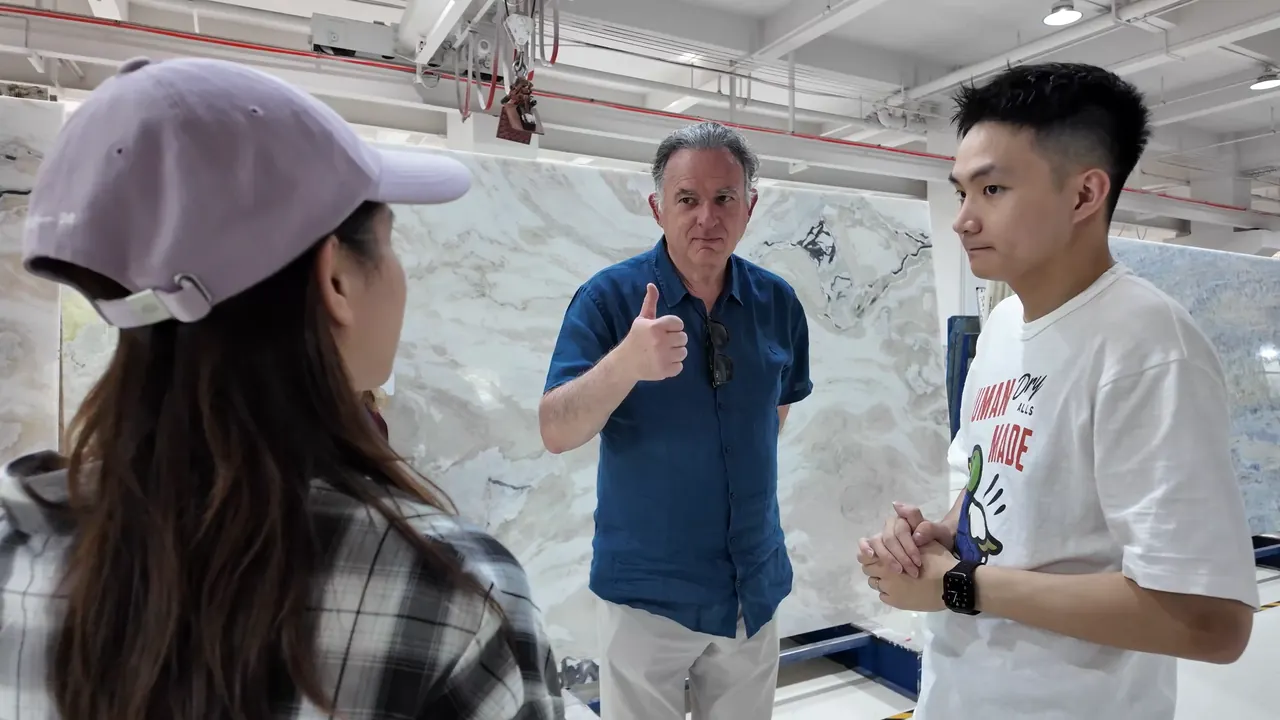 People discussing a material sample in a showroom