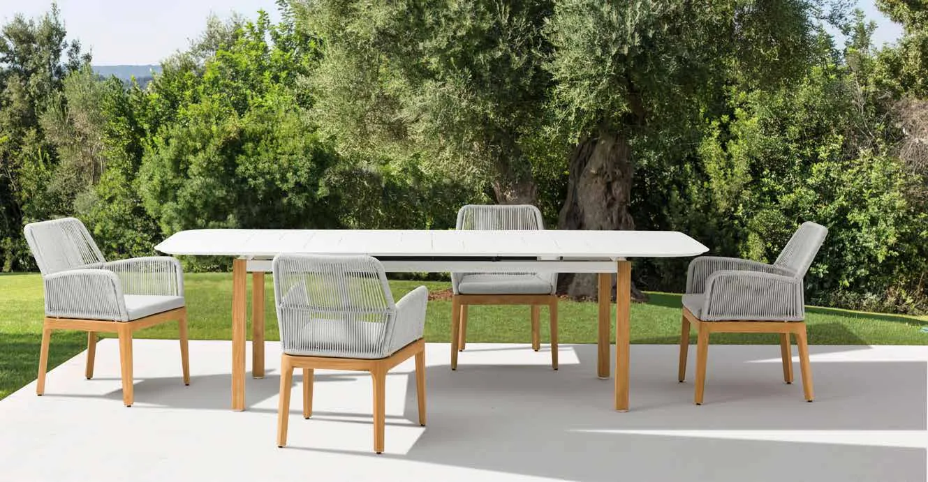 An outdoor dining table and chairs arranged on a patio.